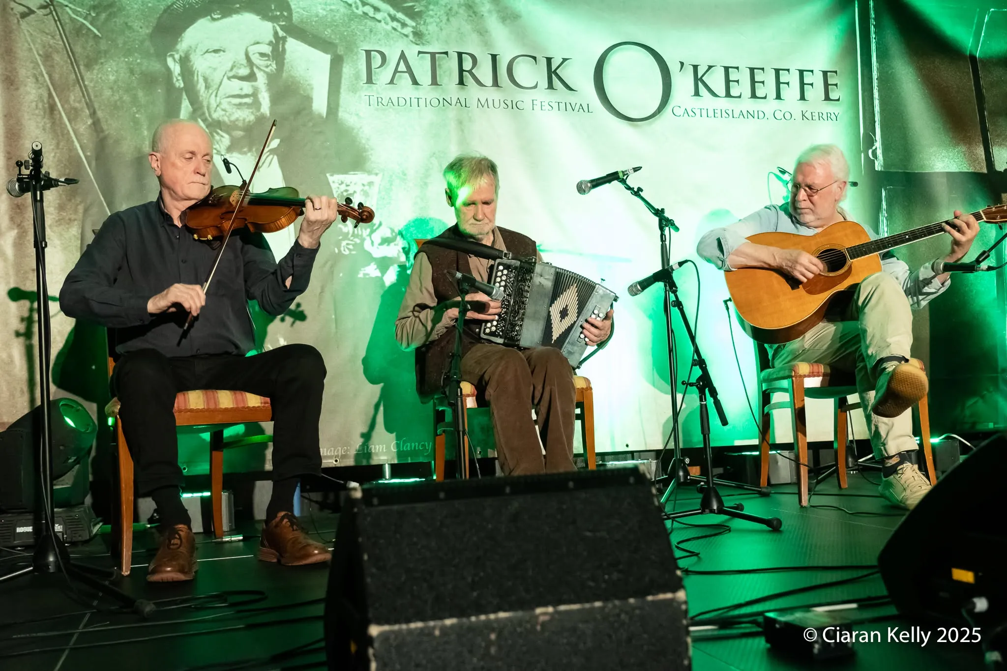 Musicians on stage in front of the Patrick O'Keeffe Festival banner at the 2025 festival
